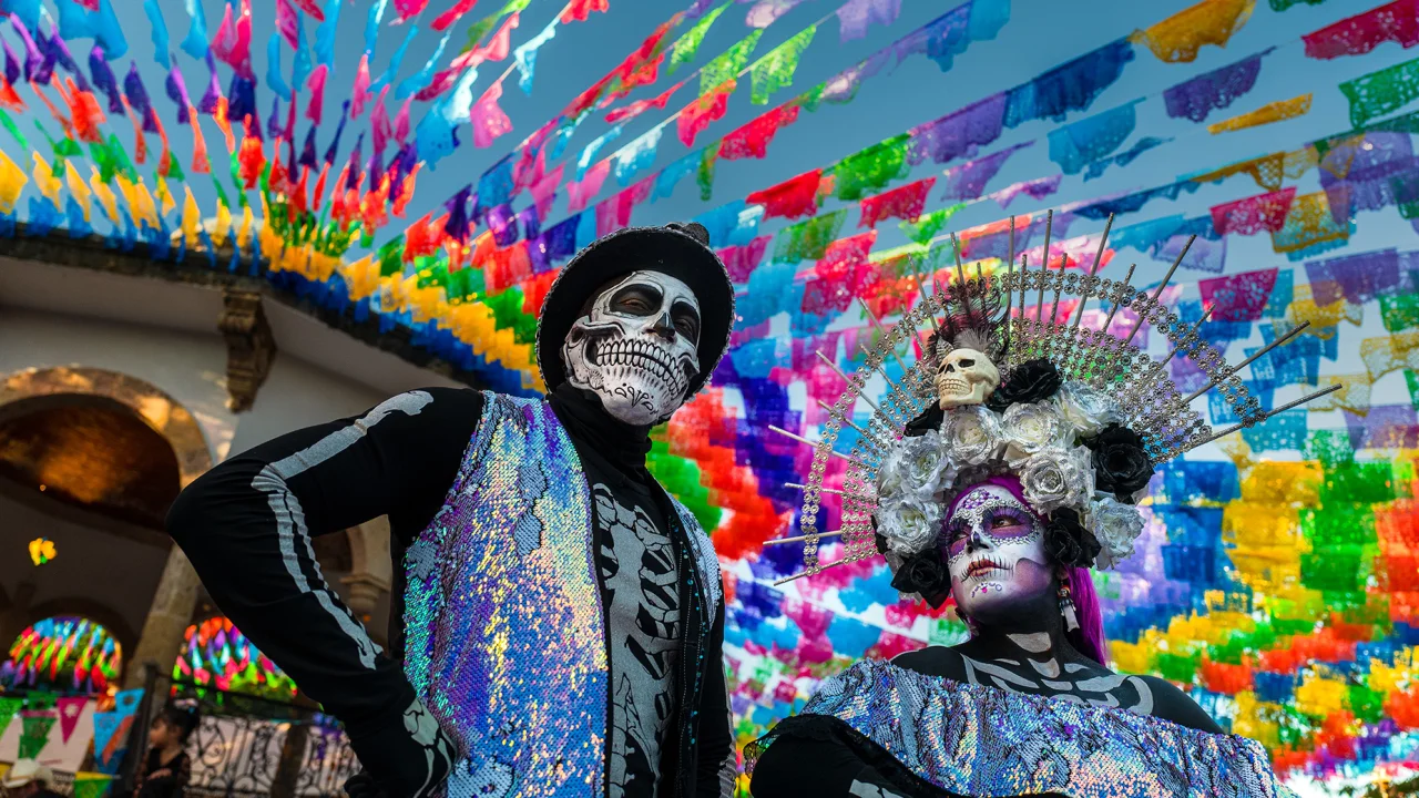 A young woman, dressed as La Catrina, and a young man, dressed as Catrin, particpate in the Day of the Dead festivities on October 31, 2022 in Jalisco, Mexico.
