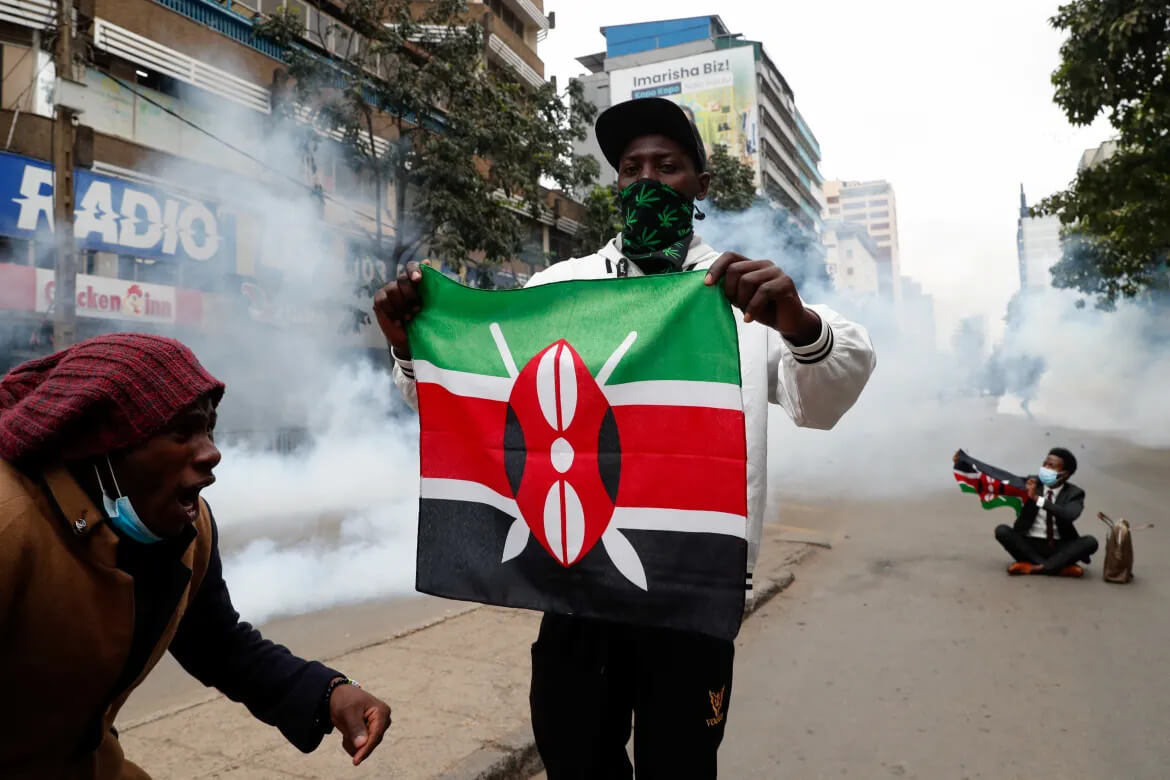 Demonstrators wave flags during an anti-government protest in Kenya's capital city.