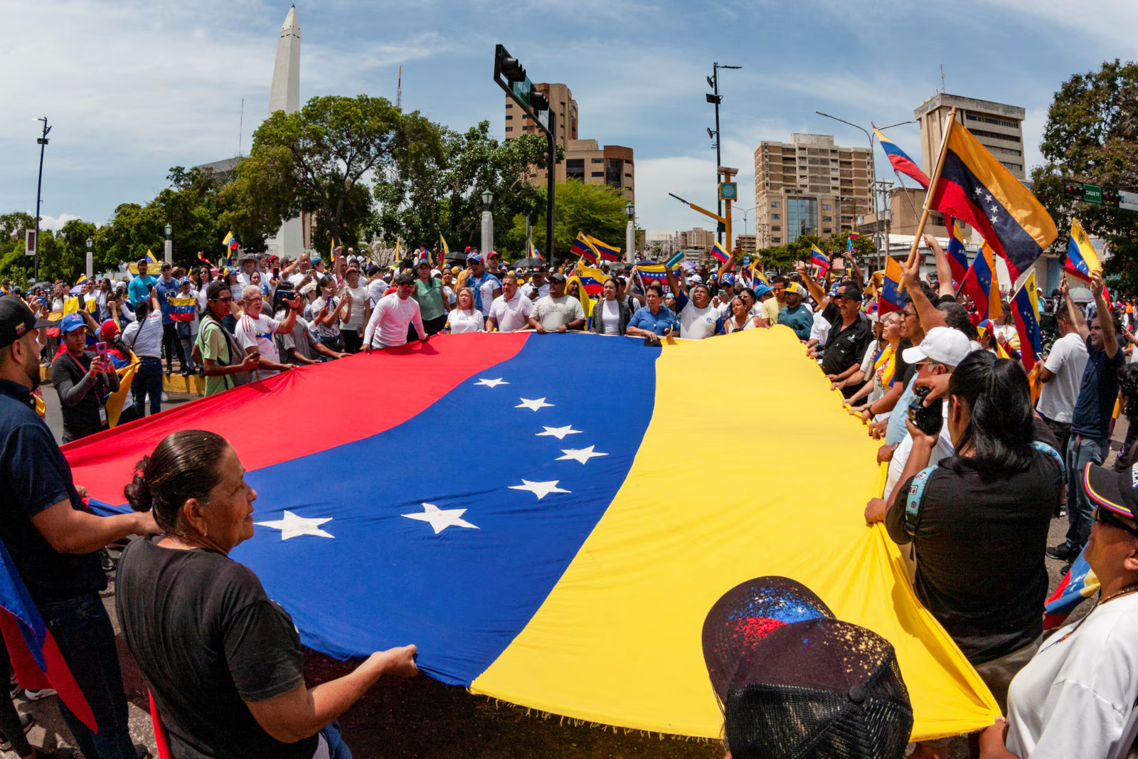 Demonstrators hold Venezuela's national flag to contest the election outcome that granted President Nicolas Maduro a third term, in Maracaibo, Venezuela.