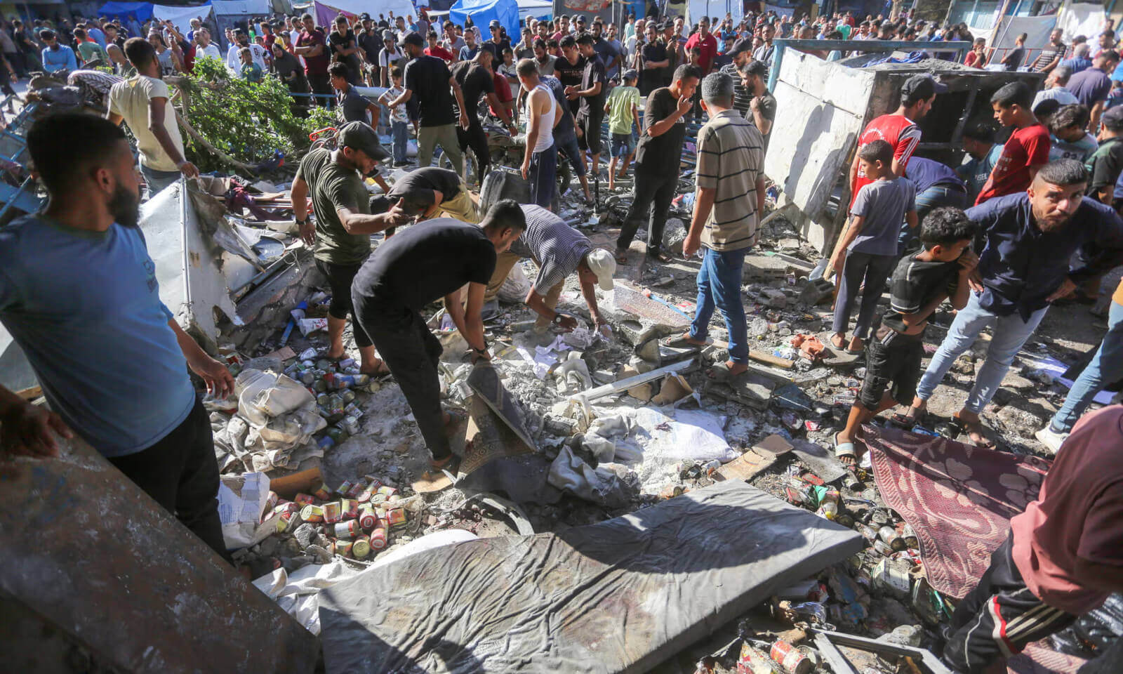 Rescue efforts underway at Unrwa school in Nuseirat, Gaza, following Israeli strike.