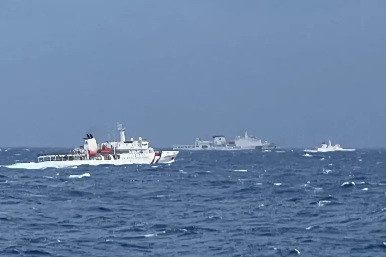 A Chinese coastguard ship, centre, is seen past Taiwan coastguard vessels in waters east of Taiwan on December 8, 2024 [Handout/Taiwan Coast Guard via AFP]