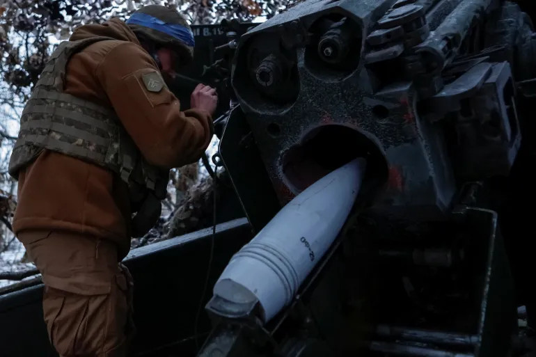 A serviceman of 13th Operative Purpose Brigade 'Khartiia' of the National Guard of Ukraine prepares to fire a Giatsint-B howitzer towards Russian troops at a position on a front line, in the Kharkiv region, Ukraine, on January 6, 2025 [Sofiia Gatilova/Reuters]