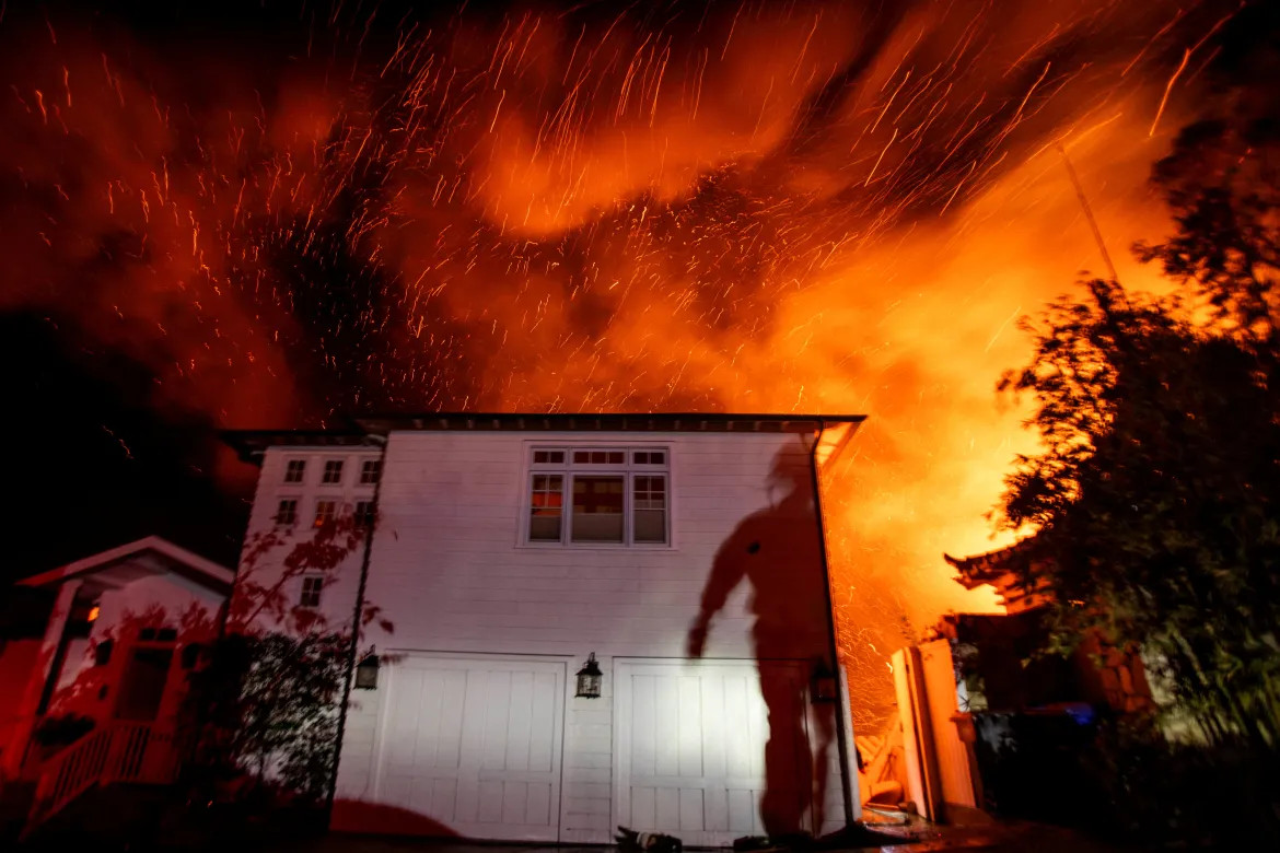 The wind whips up embers as the Palisades fire burns during a windstorm on the west side of Los Angeles, California [Ringo Chiu/Reuters]