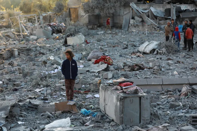 A Palestinian girl stands near the site of an Israeli attack on a house in Maghazi refugee camp in the central Gaza Strip, on January 3, 2025 [Abd Elhkeem Khaled/Reuters]