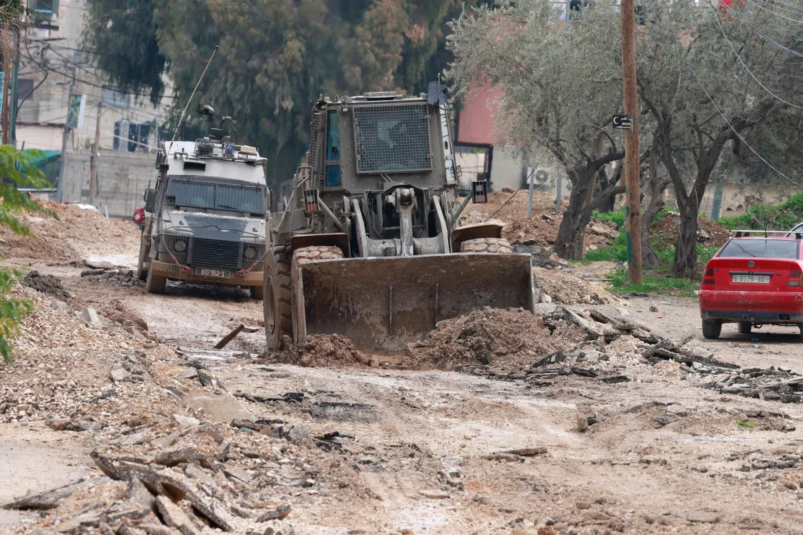 Israeli military vehicles mount a large-scale Israeli army raid on Jenin, in the occupied West Bank [Jaafar Ashtiyeh/AFP]